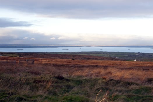 view from Knockanore hill of big ships on the river Shannon in Ireland