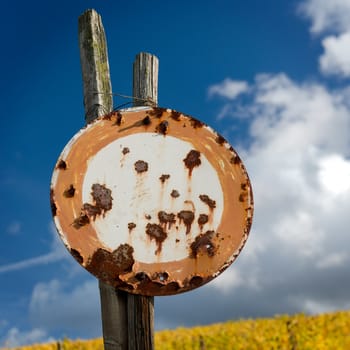 Rusty Old No Vehicles Traffic Sign Against The Blue Sky