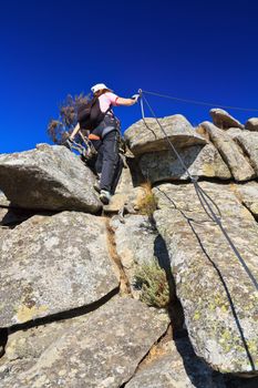 female hiker on via Fearrata in Capanne mount, Elba island, Italy