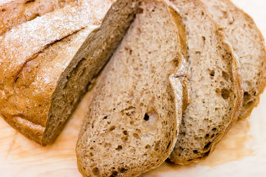 Sliced rye bread on a wooden board