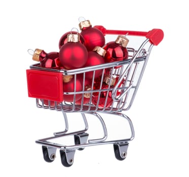 Shopping Cart With Red Christmas Balls For Decoration Isolated On White