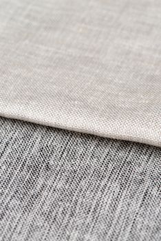 Closeup detail of grey fabric texture background.