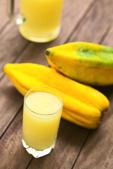 Freshly prepared juice out of the Ecuadorian Babaco fruit (lat. Vasconcellea x heilbornii; syn. Carica pentagona) (Selective Focus, Focus on the front rim of the glass)