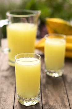 Freshly prepared juice out of the Ecuadorian Babaco fruit (lat. Vasconcellea x heilbornii; syn. Carica pentagona) (Selective Focus, Focus on the front rim of the glass)