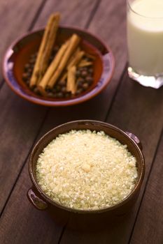 Raw Ecuadorian morocho (coarsely ground white corn) which is used in Ecuador to prepare a dessert with milk and spices similar to rice pudding (Selective Focus, Focus into the middle of the morocho) 