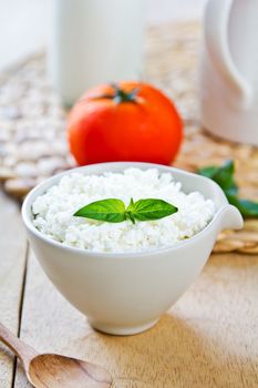 Homemade Ricotta cheese by a jug of milk
