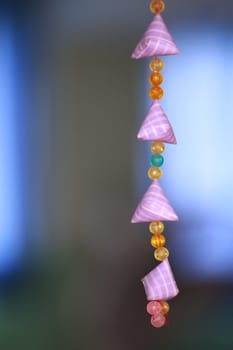 Handicraft mobile made from glass beads and ribbon.