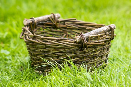 An empty wicker basket on the grass 