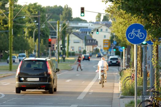 Cyclist passing by at an urban cycle path