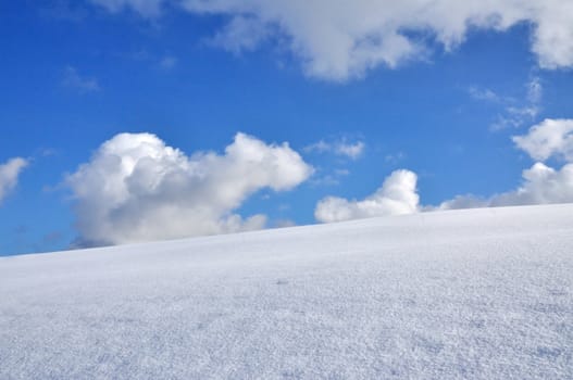 Snowy Mountainside and Blue Sky