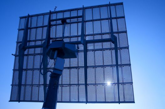 Solar Panels Silhouette Against Blue Sky