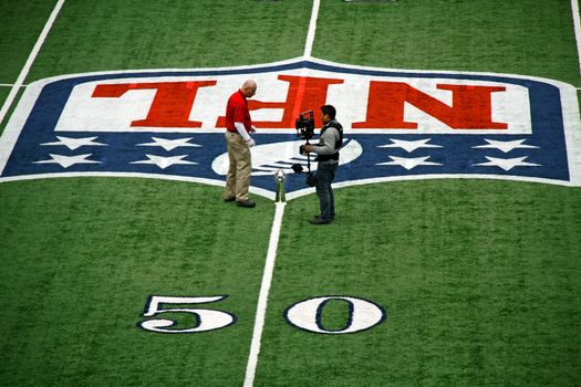 ARLINGTON - JAN 26: In preparation for the Packers Steelers Super Bowl XLV an unidentified cameraman and worker discuss placement of the Vince Lombardi trophy in Cowboys Stadium in Arlington, Texas. Taken January 26, 2011 in Arlington, TX.