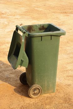 Green rubbish bin open lid at outdoor