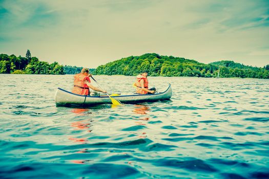 Two young men in a canoe in wild waters