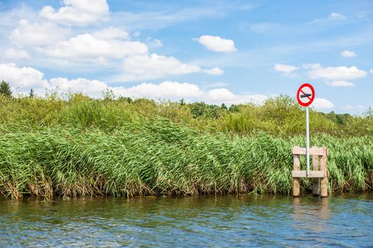 Lake scenery with a red no boating sign