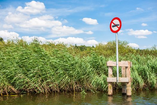 Lake scenery with a red no boating sign