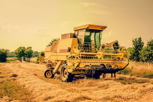 Agricultural harvester machine on a dry landscape