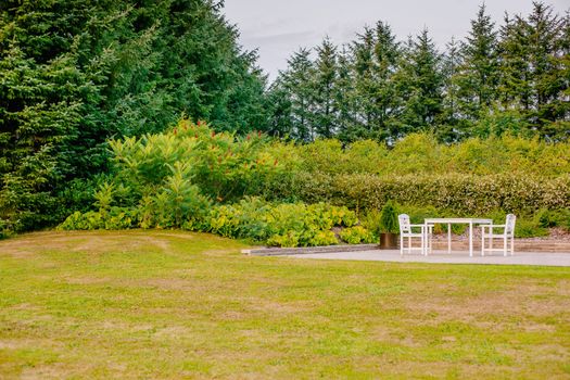 White garden furniture on a terrace in the nature