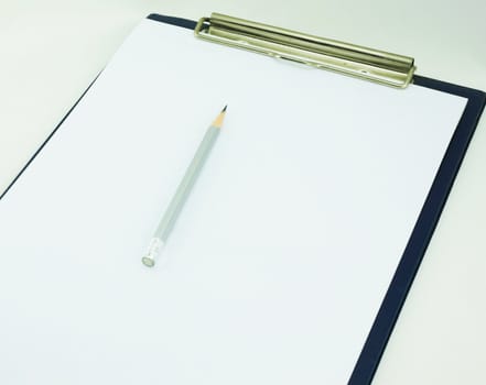 The white paper laid on board for writing notes, top with a black pencil sticks.                               