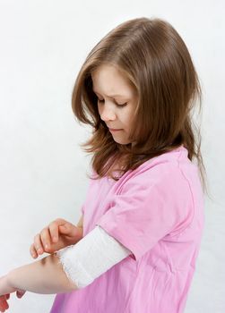 Childhood trauma. A child with a bandage tied hand