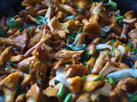 fried mushrooms with vegetables in a frying pan.