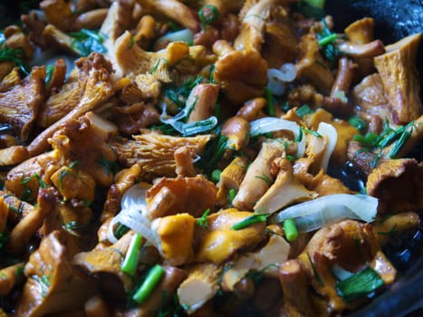 fried mushrooms with vegetables in a frying pan.