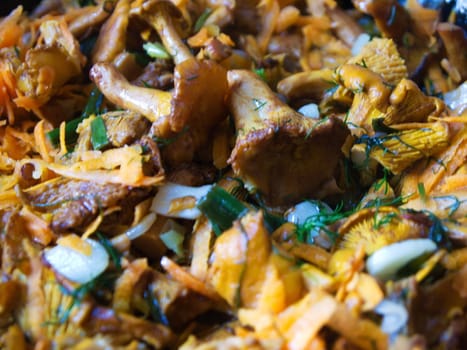 fried mushrooms with vegetables in a frying pan.