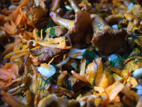 fried mushrooms with vegetables in a frying pan.