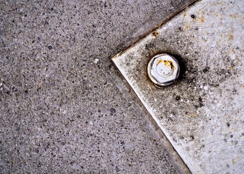 old white steel plate with screws and nut on concrete