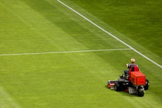 Mowing grass in a football stadium