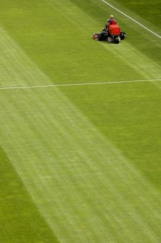 Mowing grass in a football stadium