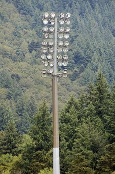 Stadium Lights With a Forest in the Background