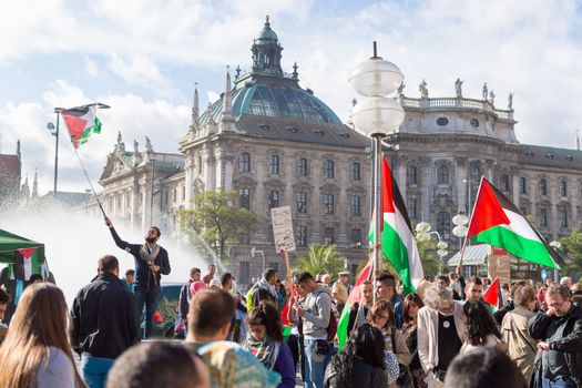 MUNICH, GERMANY - AUGUST 16, 2014: Peaceful demonstration for stopping Israel-Palestine conflict and ceasefire in Gaza Strip. Activist group calls negotiations between the warring parties.