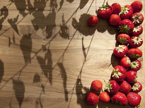Fresh ripe red strawberries on wooden textured table top