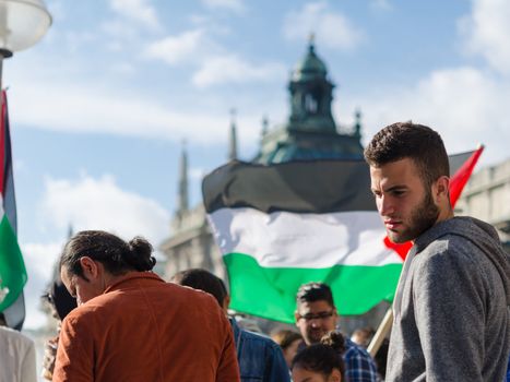 MUNICH, GERMANY - AUGUST 16, 2014: Young European activists at the demonstration. Demonstrators demanding that the government to exert pressure on Israel to end the fighting in the Gaza Strip and the withdrawal from the occupied Palestinian territories.