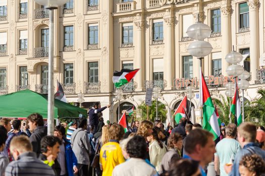MUNICH, GERMANY - AUGUST 16, 2014: Palestinian flags over the German city. Anti-war rally demanding an end to the bombing of Gaza and the withdrawal of Israeli troops from Palestine.
