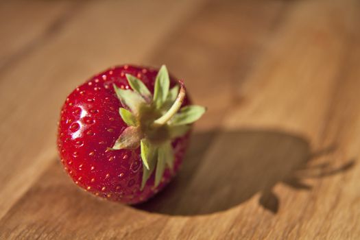 Fresh ripe red strawberrie on wooden textured table top