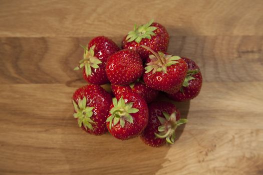 Fresh ripe red strawberries on wooden textured table top