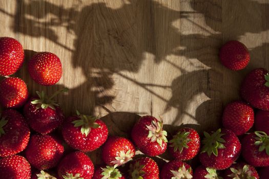 Fresh ripe red strawberries on wooden textured table top