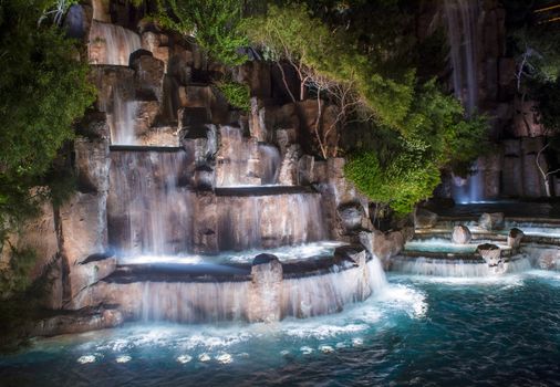 LAS VEGAS - MARCH 15 : Waterfall in front of the entrance to the Wynn Hotel and Casion on March 15, 2014 in Las Vegas. The hotel has 2,716 rooms and it opened in 2005.