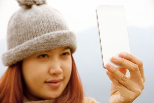 Happy Asian women looking at her cellphone