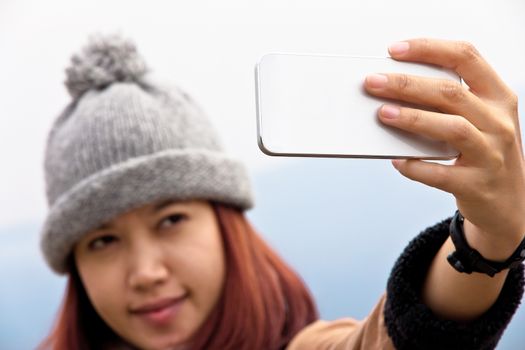 Happy Asian women looking at her cellphone