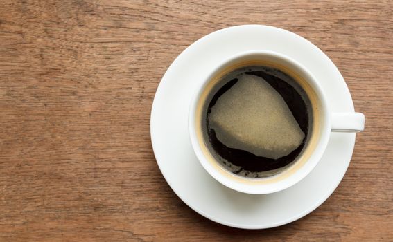 Top view cup of black  coffee on wooden