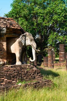 Elephants statues on ruins of Buddhist stupa or chedi in Sukhothai historical park in Wat Chang Lom temple. 