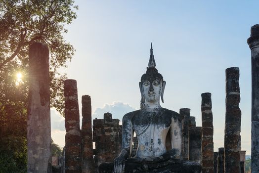 Buddha statue in old Buddhist temple ruins. Buddha statue in Sukhothai historical park Wat Mahathat.