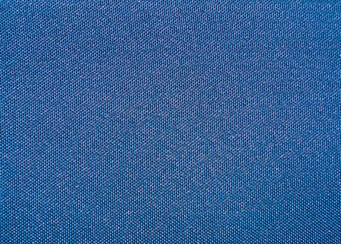 Texture of a blue woven synthetic waterproof fabric closeup