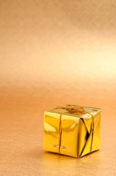 Beautiful gold gift box with gold background