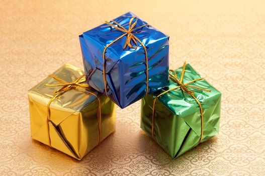 Beautiful wrapped christmas presents with gold background