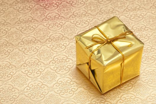 Beautiful wrapped christmas presents with gold background