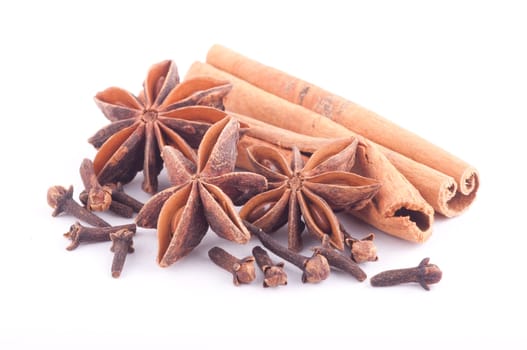 Cinnamon sticks, star anise and cloves isolated on white